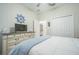Bright bedroom with a ceiling fan, TV, white dresser, coastal decor, and lots of natural light at 8907 Fallen Oak, Davenport, FL 33897