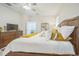 Comfortable bedroom with a wooden bed frame, soft bedding, and natural light at 8907 Fallen Oak, Davenport, FL 33897