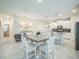 Open concept living with a dining table and chairs next to the bright and spacious kitchen area at 8907 Fallen Oak, Davenport, FL 33897