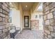 Inviting front entrance with a decorative bench, brick columns, and a stylish front door at 8907 Fallen Oak, Davenport, FL 33897