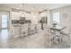 Bright kitchen with white cabinetry, stainless steel appliances, and center island with barstool seating at 8907 Fallen Oak, Davenport, FL 33897