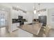 Bright kitchen with bar seating, stainless steel appliances, and ample white cabinetry for storage and modern living at 8907 Fallen Oak, Davenport, FL 33897
