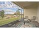 Relaxing screened-in lanai with seating and a beautiful view of the surrounding green landscape at 8907 Fallen Oak, Davenport, FL 33897