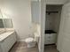 A half bathroom with a vanity and cabinet with a closet at 911 N Orange Ave # 545, Orlando, FL 32801