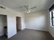 This carpeted bedroom features a ceiling fan and a doorway leading to an additional space at 911 N Orange Ave # 545, Orlando, FL 32801
