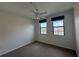 This bedroom features carpeted floors and two windows with a view at 911 N Orange Ave # 545, Orlando, FL 32801