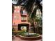 Courtyard view of a peach colored building with a fountain at 911 N Orange Ave # 545, Orlando, FL 32801
