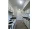 Efficient kitchen layout featuring white appliances, ample counter space, and modern flooring at 911 N Orange Ave # 545, Orlando, FL 32801