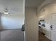 View into carpeted living room and kitchen area, showing an open-concept layout of the home at 911 N Orange Ave # 545, Orlando, FL 32801