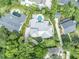 An aerial view of the property highlighting the house, in-ground pool, and lush landscaping at 940 Lincoln Cir, Winter Park, FL 32789