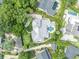 Stunning aerial view of a luxury home with a private pool, lush landscaping, and a circular driveway at 940 Lincoln Cir, Winter Park, FL 32789