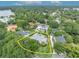 An aerial shot showing lush greenery and upscale houses, with a boundary line at 940 Lincoln Cir, Winter Park, FL 32789