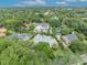 Expansive aerial view of a neighborhood showcasing lush greenery and stately homes with swimming pools at 940 Lincoln Cir, Winter Park, FL 32789