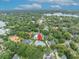An aerial shot with a home pinpointed in a beautiful neighborhood with a lake and lots of green landscaping at 940 Lincoln Cir, Winter Park, FL 32789