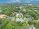 Aerial view of neighborhood showcasing property lines, lush greenery and stately homes with swimming pools at 940 Lincoln Cir, Winter Park, FL 32789