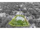 Highlighted aerial view showing property lines and landscaping surrounded by lush greenery in black and white at 940 Lincoln Cir, Winter Park, FL 32789