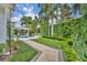 Professionally landscaped backyard with luxurious pool, entertainment area, plush lawn, and brick paver path at 940 Lincoln Cir, Winter Park, FL 32789