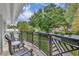Charming balcony featuring wrought iron railings and a view of lush landscaping and the neighborhood at 940 Lincoln Cir, Winter Park, FL 32789
