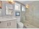 Bathroom featuring a glass shower, marble vanity and updated lighting at 940 Lincoln Cir, Winter Park, FL 32789