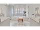 Bathroom featuring soaking tub, walk-in shower, and dual vanities with marble countertops at 940 Lincoln Cir, Winter Park, FL 32789