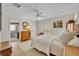 Inviting bedroom featuring hardwood floors, shutters, and access to the bathroom at 940 Lincoln Cir, Winter Park, FL 32789