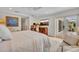 Bedroom featuring white walls, hardwood flooring, sitting area and exterior door leading to backyard at 940 Lincoln Cir, Winter Park, FL 32789