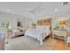 Bedroom featuring white walls, hardwood flooring and a cozy sitting area with plenty of natural light at 940 Lincoln Cir, Winter Park, FL 32789
