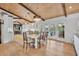 Dining area with wood-beamed ceilings, hardwood floors, and seamless flow to the kitchen and outdoor patio at 940 Lincoln Cir, Winter Park, FL 32789