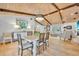 Dining room with wood-beamed ceilings and hardwood floors with a view of the living room at 940 Lincoln Cir, Winter Park, FL 32789