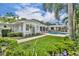 Expansive backyard with lush landscaping, manicured lawn, in-ground pool, and outdoor entertainment area at 940 Lincoln Cir, Winter Park, FL 32789