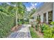 Well manicured walkway to the side entrance lined with beautiful foliage and colorful flowers at 940 Lincoln Cir, Winter Park, FL 32789