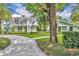 Stunning two-story home with a beautifully landscaped yard and a curved brick driveway at 940 Lincoln Cir, Winter Park, FL 32789