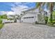 Home exterior featuring a three car garage, side entrance, and a driveway paved with brick pavers at 940 Lincoln Cir, Winter Park, FL 32789