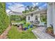 Picturesque garden with colorful blue planters, potting area, and a beautiful brick paver pathway at 940 Lincoln Cir, Winter Park, FL 32789