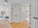 Hallway featuring hardwood flooring, white walls and doors leading to other rooms in the home at 940 Lincoln Cir, Winter Park, FL 32789