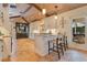 Kitchen with white cabinets, granite counters, and an island with barstool seating at 940 Lincoln Cir, Winter Park, FL 32789