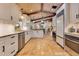 Bright kitchen with white cabinets, stainless steel appliances, and stone tile floors at 940 Lincoln Cir, Winter Park, FL 32789