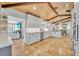 Bright open kitchen with an island bar, wooden ceiling beams and tan tile floors at 940 Lincoln Cir, Winter Park, FL 32789