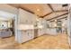 White kitchen with stainless steel appliances, breakfast bar and stone tile flooring at 940 Lincoln Cir, Winter Park, FL 32789