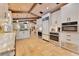 Bright kitchen with white cabinets, stainless steel appliances, and travertine tile flooring at 940 Lincoln Cir, Winter Park, FL 32789