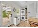 Laundry room featuring stacked washer and dryer, sink and access to the outdoors at 940 Lincoln Cir, Winter Park, FL 32789