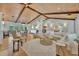 Bright living room offers wood-beamed ceilings, and white furnishings. Dining area visible in the background at 940 Lincoln Cir, Winter Park, FL 32789
