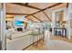 Open-concept home showcasing stylish living room with fireplace, wood floors, and beamed ceilings at 940 Lincoln Cir, Winter Park, FL 32789