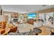 Cozy living room with lots of seating, a fireplace, a large flatscreen TV and lots of natural light at 940 Lincoln Cir, Winter Park, FL 32789