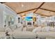 Bright living room featuring a wooden ceiling, fireplace, and an open layout leading into the kitchen at 940 Lincoln Cir, Winter Park, FL 32789