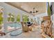 Cozy living room featuring wicker furniture, a cowhide rug, and views of the outdoor pool at 940 Lincoln Cir, Winter Park, FL 32789