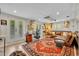 Spacious living room with eclectic decor, leather sofa, and French doors to the outside at 940 Lincoln Cir, Winter Park, FL 32789