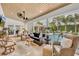 Sunroom with a ceiling fan, wicker furniture, views of the pool, and lots of natural light at 940 Lincoln Cir, Winter Park, FL 32789
