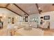 Spacious living room featuring wood beam ceiling, with hardwood flooring and neutral tones at 940 Lincoln Cir, Winter Park, FL 32789