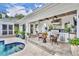 Outdoor kitchen area with a built-in grill, seating, and pool views at 940 Lincoln Cir, Winter Park, FL 32789